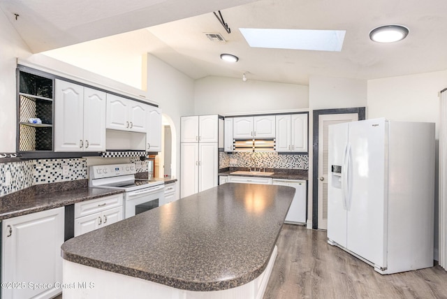 kitchen featuring white appliances, visible vents, vaulted ceiling, open shelves, and dark countertops