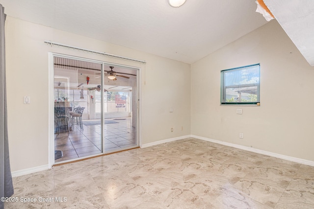 unfurnished room featuring a wealth of natural light, lofted ceiling, and baseboards