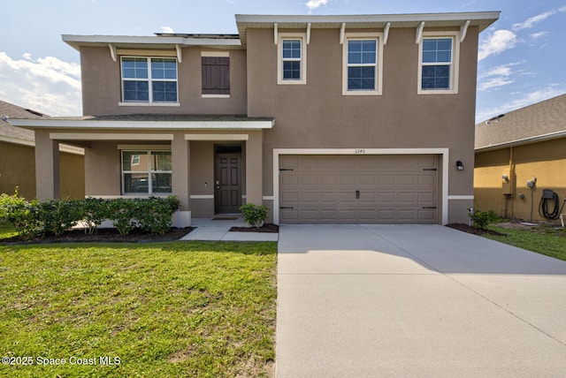 view of front of property with driveway, a front lawn, an attached garage, and stucco siding