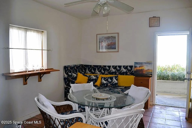 tiled dining area with a healthy amount of sunlight and ceiling fan