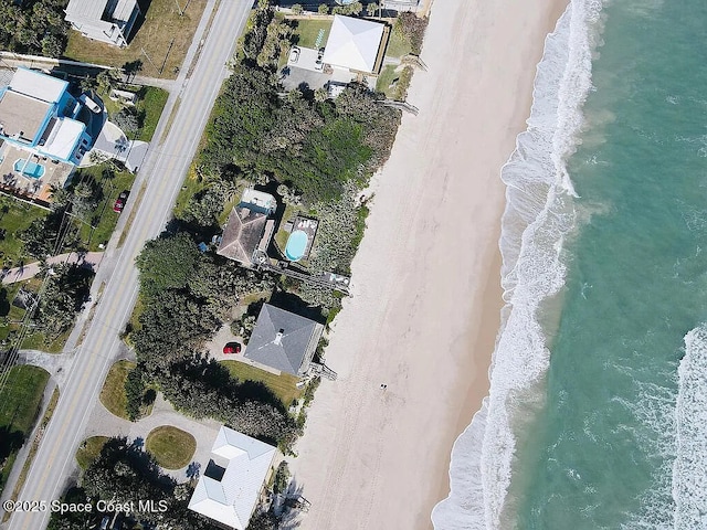 aerial view with a water view and a view of the beach