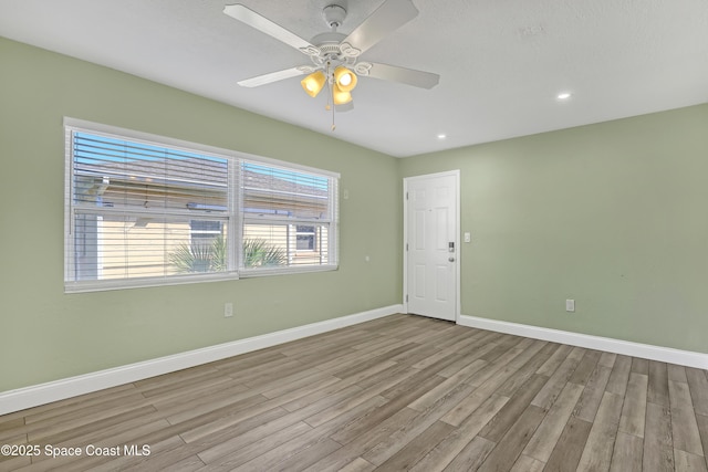 empty room featuring ceiling fan, baseboards, wood finished floors, and recessed lighting