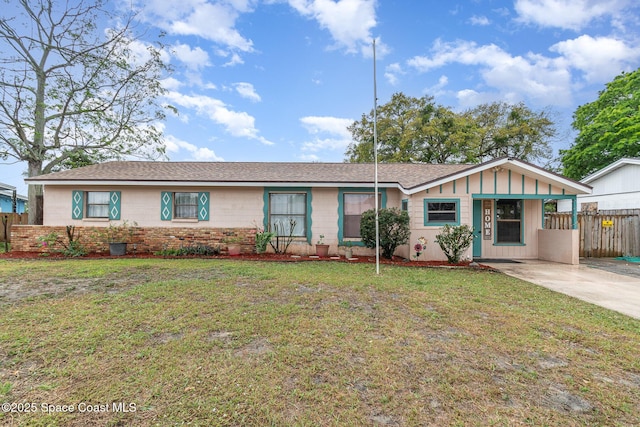 ranch-style house with a front yard, concrete driveway, fence, and board and batten siding