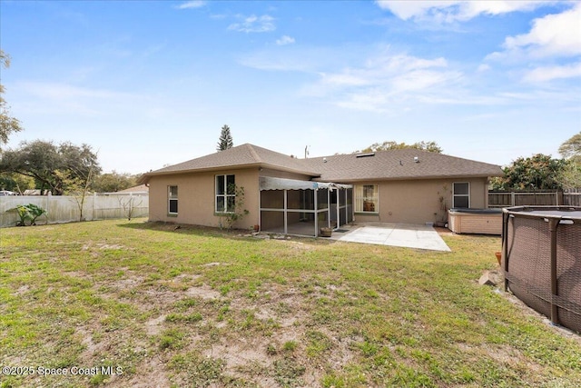 back of house with a sunroom, a fenced backyard, a patio, and stucco siding