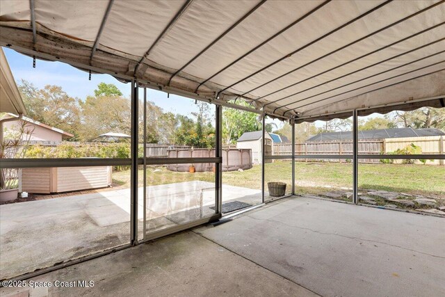 unfurnished sunroom featuring lofted ceiling