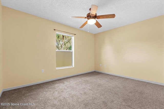 empty room featuring carpet, ceiling fan, a textured ceiling, and baseboards