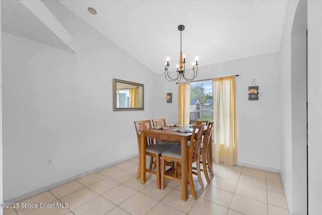 dining area with light tile patterned floors, lofted ceiling, a textured ceiling, a chandelier, and baseboards