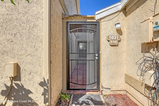 doorway to property with stucco siding