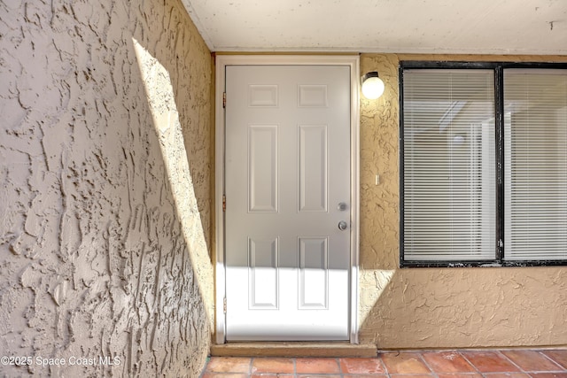 doorway to property with stucco siding