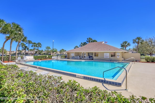 pool featuring a patio and fence