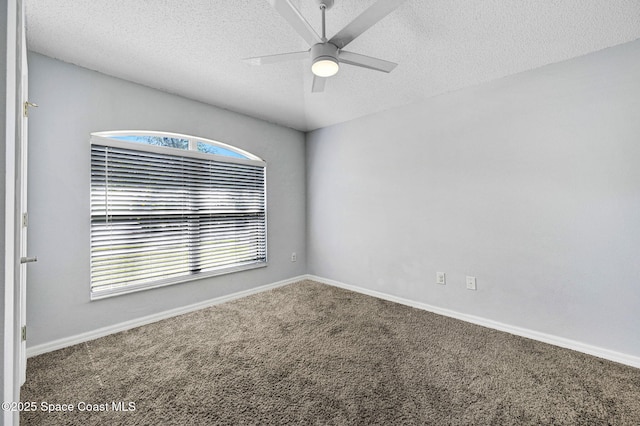 carpeted empty room featuring ceiling fan, baseboards, and a textured ceiling