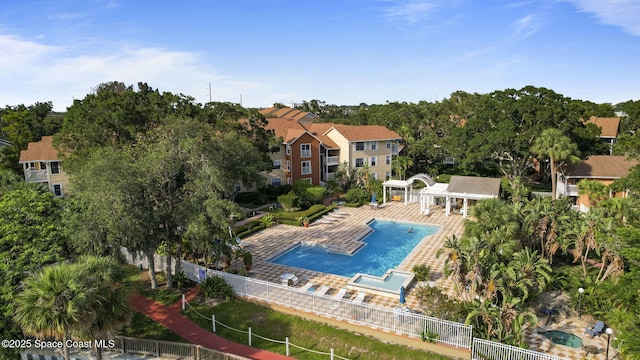 community pool featuring fence, a pergola, and a patio