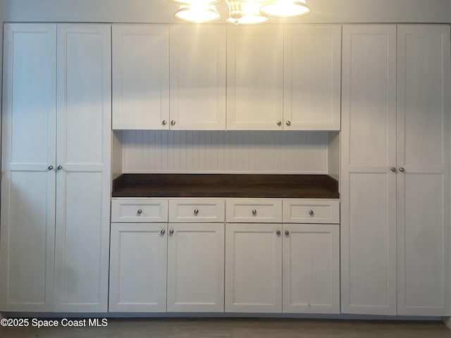 kitchen featuring dark countertops and white cabinets