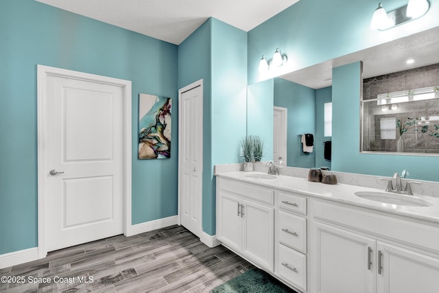 3465 Diamond Leaf Dr, Vero Beach, FL 32966 - full bathroom with baseboards, tiled shower, a sink, and wood finish floors