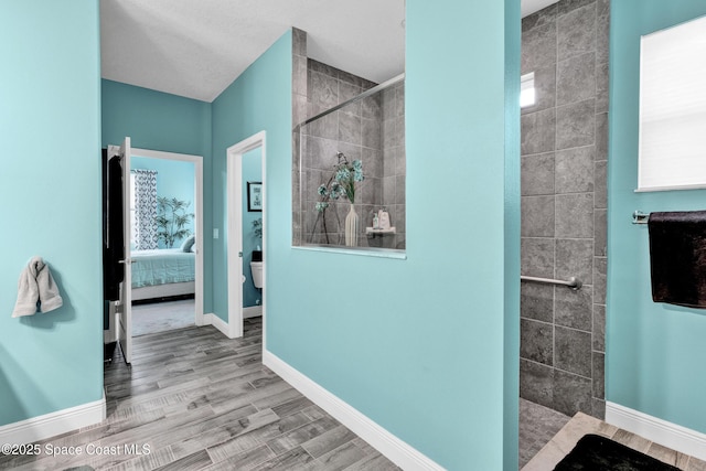 3465 Diamond Leaf Dr, Vero Beach, FL 32966 - ensuite bathroom featuring wood finished floors, connected bathroom, baseboards, and walk in shower