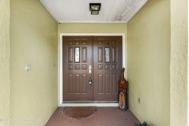 property entrance with stucco siding