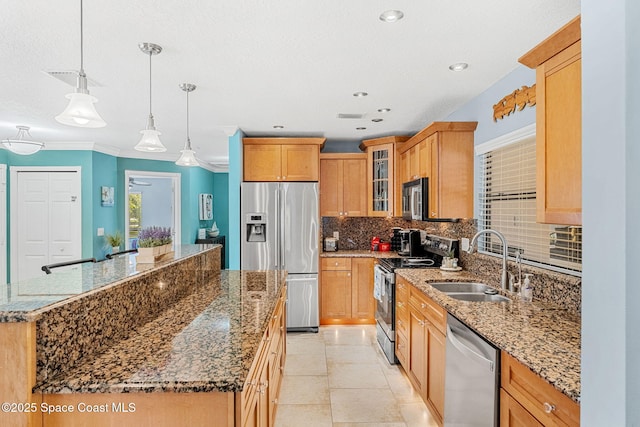 kitchen with a sink, tasteful backsplash, a center island, stainless steel appliances, and glass insert cabinets