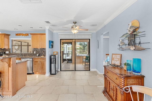 kitchen with stainless steel dishwasher, decorative backsplash, visible vents, and stone counters