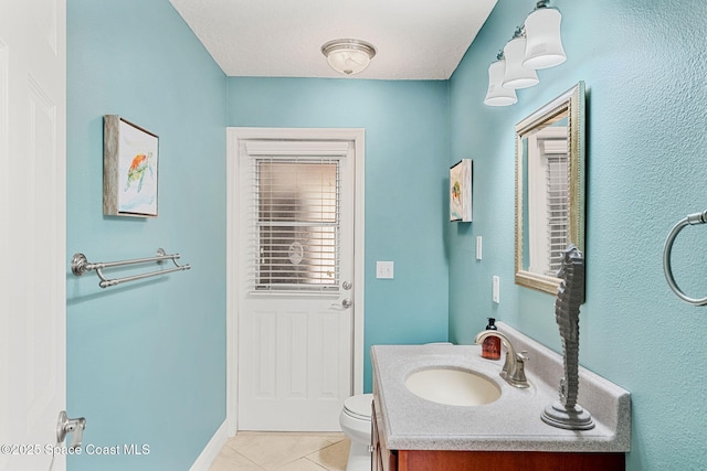 bathroom with tile patterned flooring, toilet, and vanity