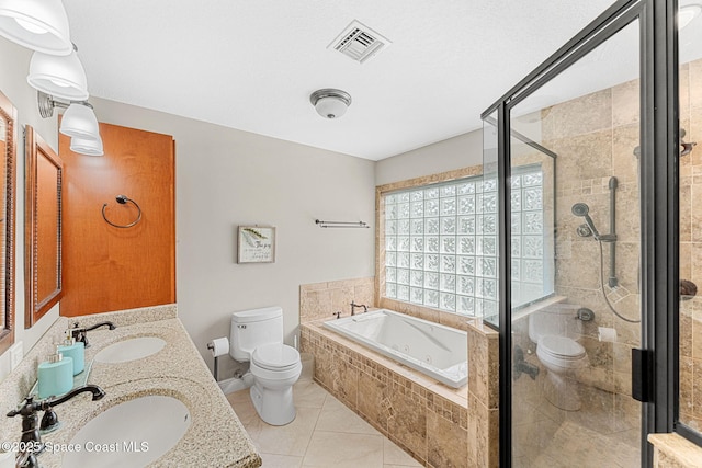 bathroom featuring toilet, a bath, visible vents, and a sink