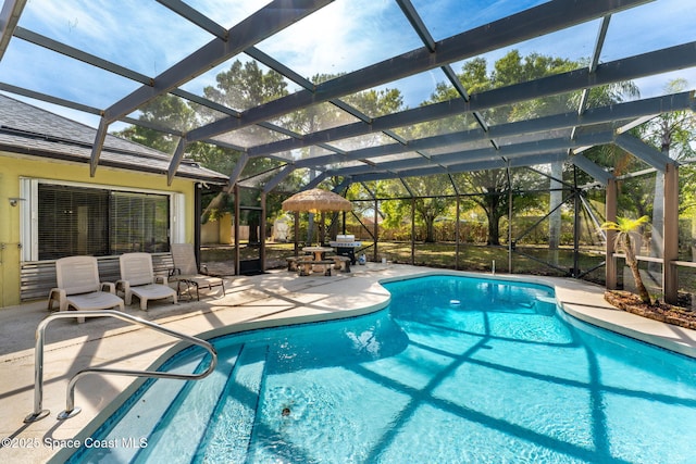 pool with a lanai and a patio area