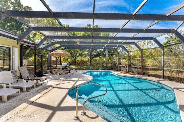 view of swimming pool with a fenced in pool, a lanai, and a patio area