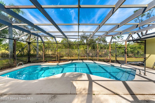 pool with glass enclosure and a patio