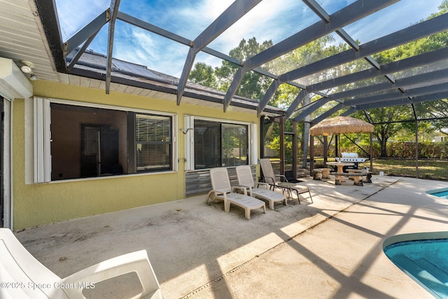 view of patio / terrace with a lanai and an outdoor pool