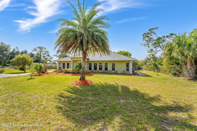 rear view of property with a lawn