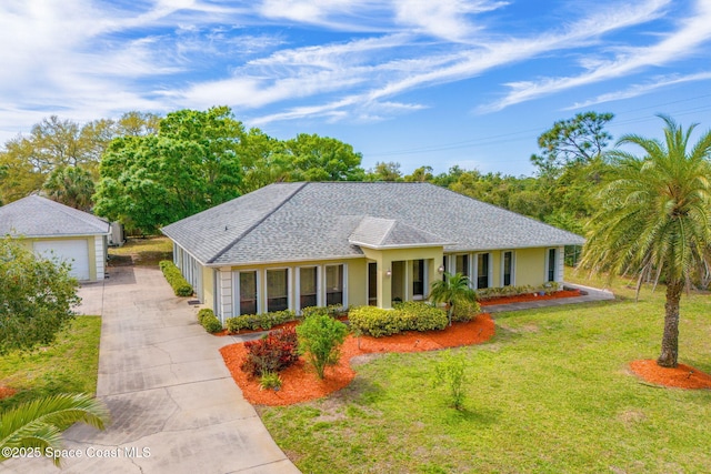 ranch-style house with a garage, roof with shingles, an outdoor structure, and a front yard