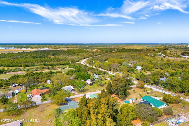 drone / aerial view featuring a forest view