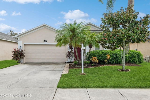 ranch-style home with a garage, a front yard, concrete driveway, and stucco siding