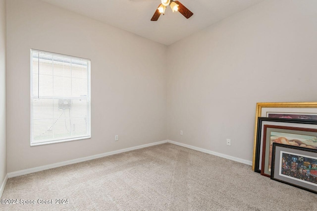 carpeted spare room featuring baseboards, ceiling fan, and a healthy amount of sunlight