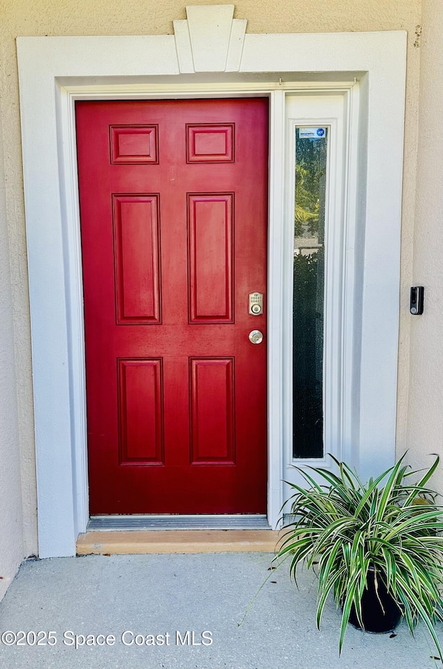 view of exterior entry with stucco siding