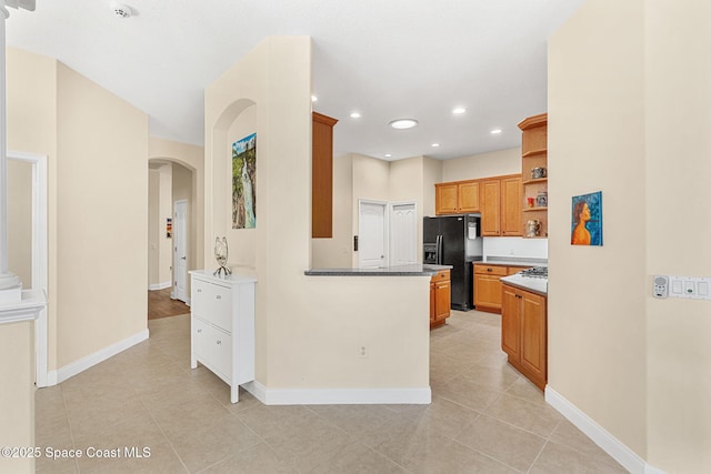 kitchen with baseboards, open shelves, recessed lighting, arched walkways, and black refrigerator with ice dispenser