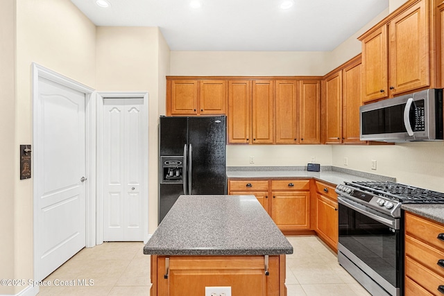 kitchen featuring light tile patterned flooring, recessed lighting, a center island, and stainless steel appliances