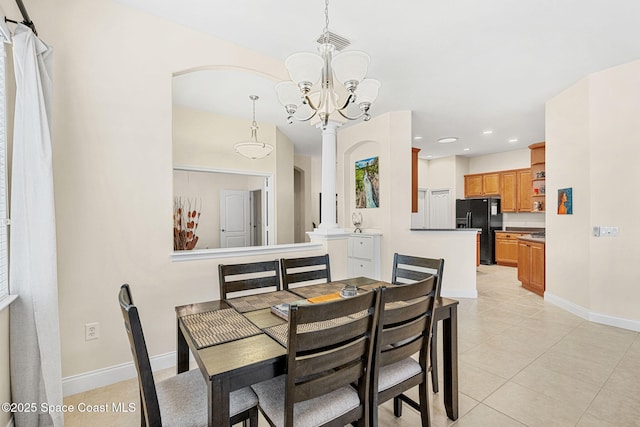 dining room with decorative columns, baseboards, visible vents, and light tile patterned flooring