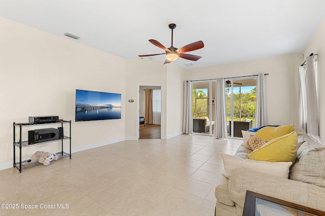 living room featuring light tile patterned floors, visible vents, a ceiling fan, and baseboards