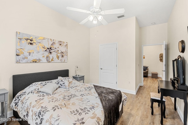 bedroom with light wood-type flooring, baseboards, visible vents, and ceiling fan