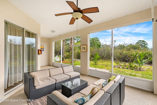 sunroom / solarium featuring a healthy amount of sunlight and ceiling fan