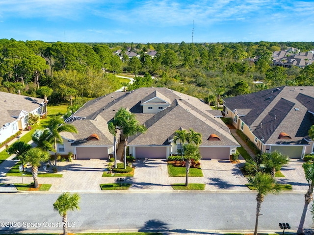 drone / aerial view with a wooded view