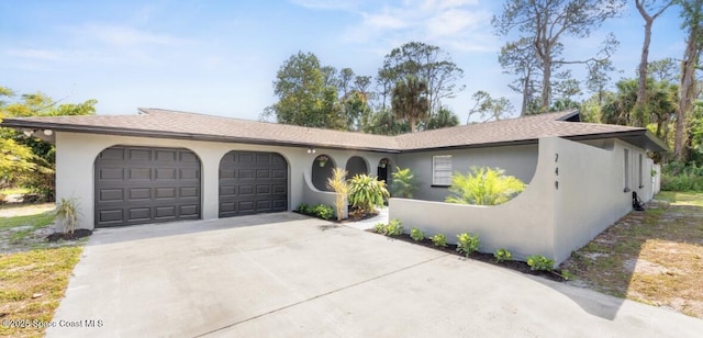 ranch-style house with stucco siding, concrete driveway, and a garage