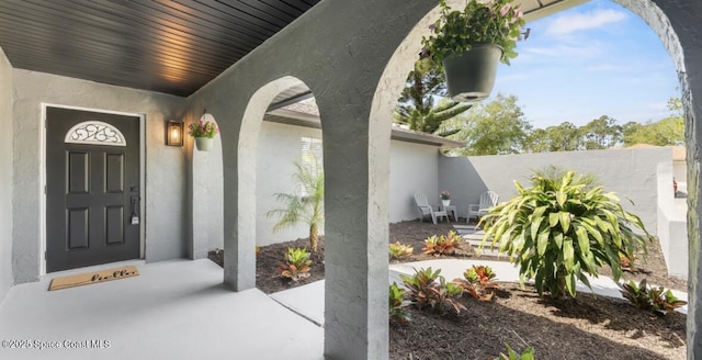 entrance to property featuring stucco siding