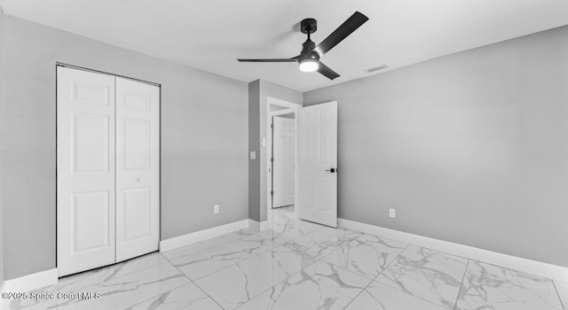 unfurnished bedroom with visible vents, baseboards, ceiling fan, a closet, and marble finish floor