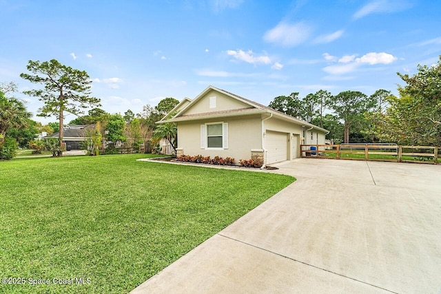 single story home with stucco siding, concrete driveway, an attached garage, fence, and a front lawn