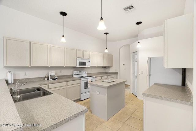 kitchen with light countertops, visible vents, hanging light fixtures, a sink, and white appliances