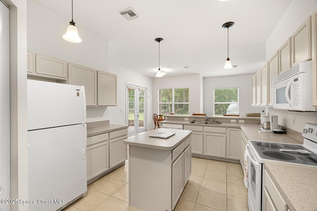 kitchen with white appliances, light tile patterned floors, visible vents, light countertops, and a sink