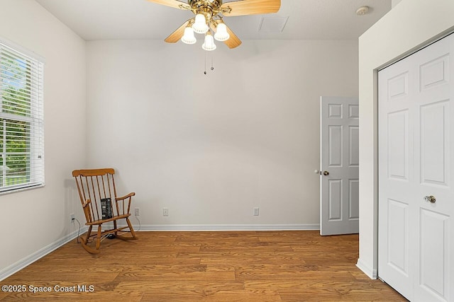 sitting room with a healthy amount of sunlight, light wood-type flooring, and baseboards