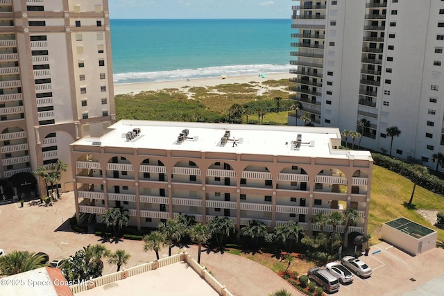 exterior space with a water view and a beach view