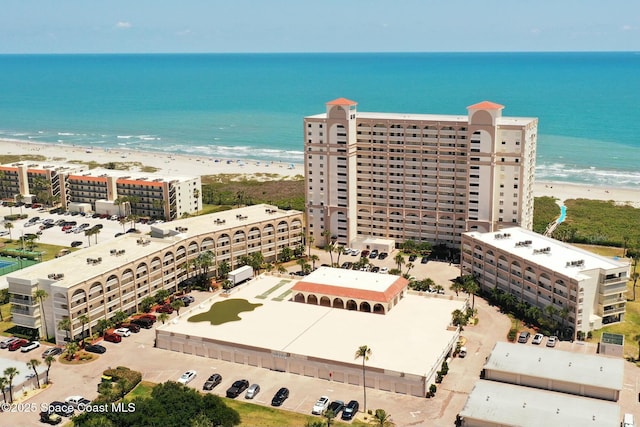 bird's eye view featuring a view of the beach and a water view